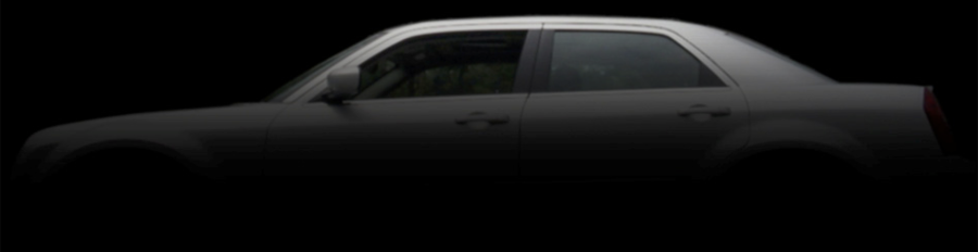 A car is shown in the dark with its door open.